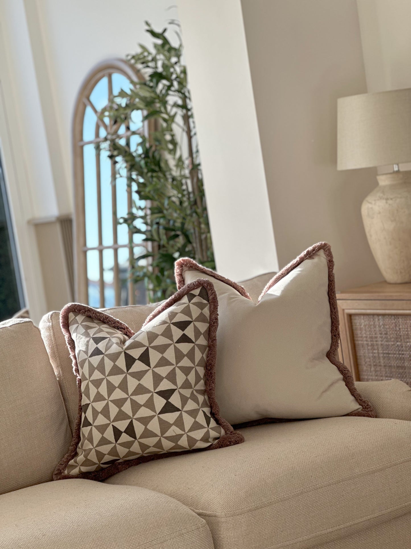 Natural and taupe patterned pillow cover with soft textured edging — ideal for calm, layered interiors.